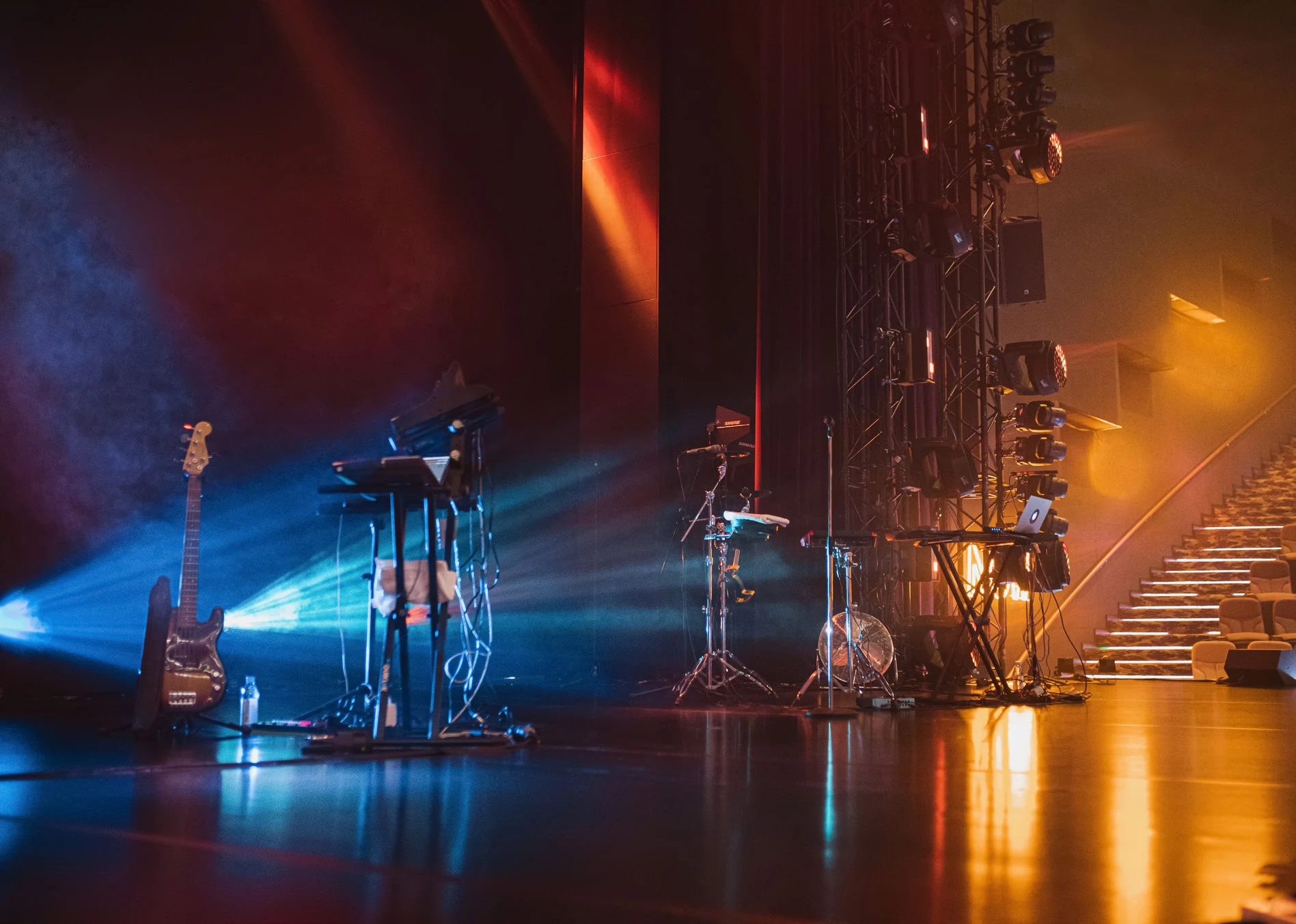 Dramatic blue and amber lights fill an event stage